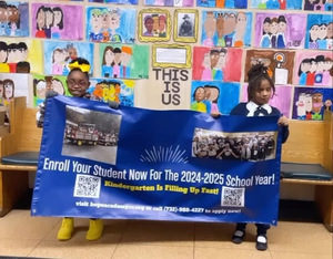 Students holding an enrollment info banner